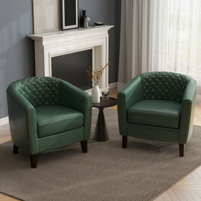 Fauteuil demi-tonneau capitonné avec garniture cloutée Edvardas