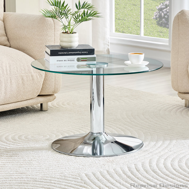 Table basse ronde en verre trempé de 27,5 pouces de diamètre. 17,7 pouces de haut, soutenu par une base en métal argenté, avec un bord de luxe léger.