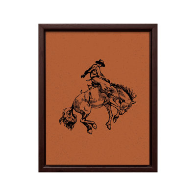 Cowboy brun chevauchant un cheval sauvage