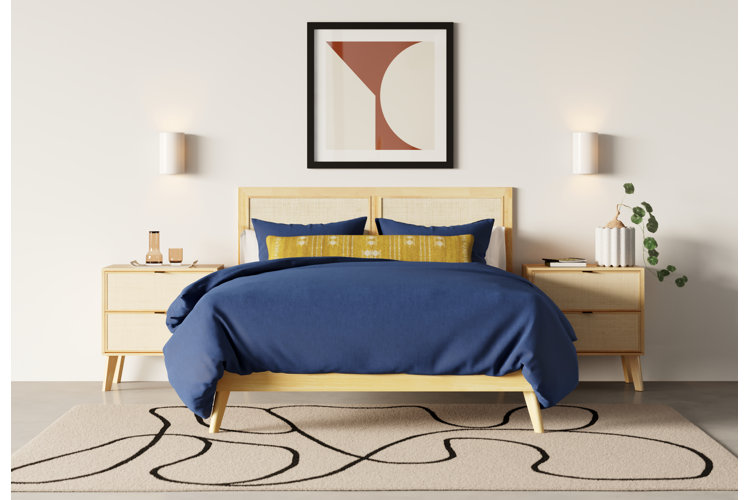 Simple modern bedroom with bed with blue bedding and simple white wall sconces