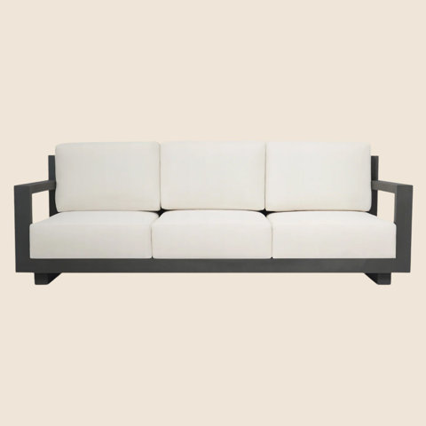 Gray framed sofa with three white cushions.