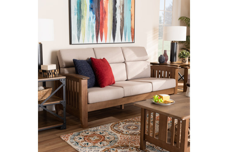 Mission-style living room with a beige upholstered wood sofa and a solid-wood coffee table.
