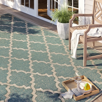 Tapis intérieur / extérieur turquoise clair à motif géométrique Broddrick