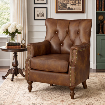 Fauteuil Redi vintage à oreilles de 75 cm de large, recouvert de similicuir et doté de pieds en bois massif.