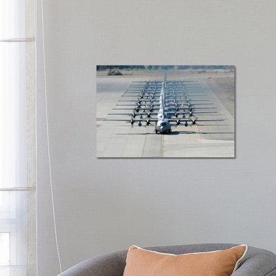 A Line Of C-130 Hercules Taxi At Nellis Air Force Base, Nevada by Stocktrek Images - Wrapped Canvas Print