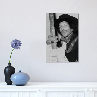 A Smiling Jimi Hendrix Holding His Guitar by Radio Days - Print on Canvas
