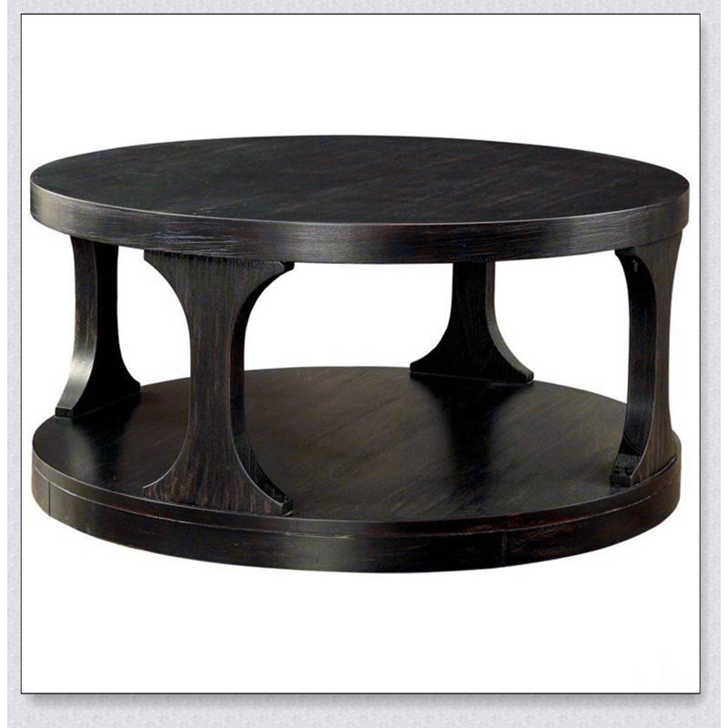 Table basse ronde de style transitionnel au fini noir antique avec tablette de rangement supplémentaire et pieds au design complexe