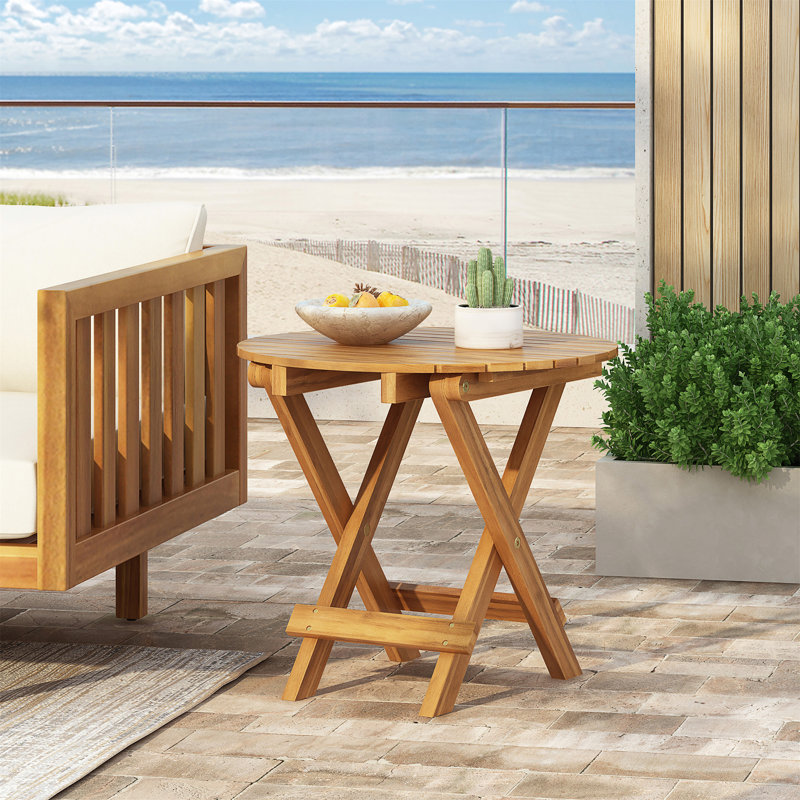 Table d'appoint pliable et réglable en bois d'acacia avec finition en teck pour plus de commodité et d'économie d'espace.