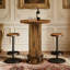Table de bar ronde rustique en bois aggloméré industriel avec anneau repose-pieds en métal et colonne en faux grain de bois, pour bar, restaurant ou salon à la maison