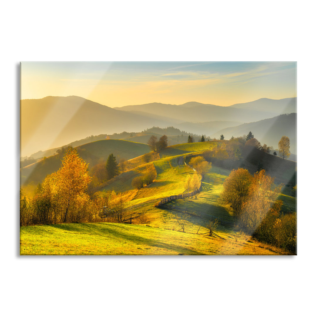 Glasbild Hügelige Herbstlandschaft bei Sonnenuntergang