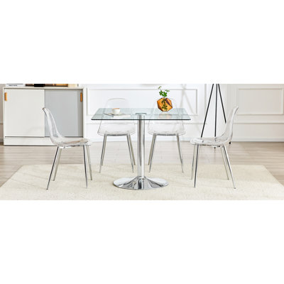 Ensemble de table et de chaises Table de salle à manger carrée en verre moderne minimaliste de 38,5 pouces avec base en métal argenté. Comprend 4 chaises en plastique transparent avec des pieds en métal argenté. Apportez une expérience confortable à la maison.