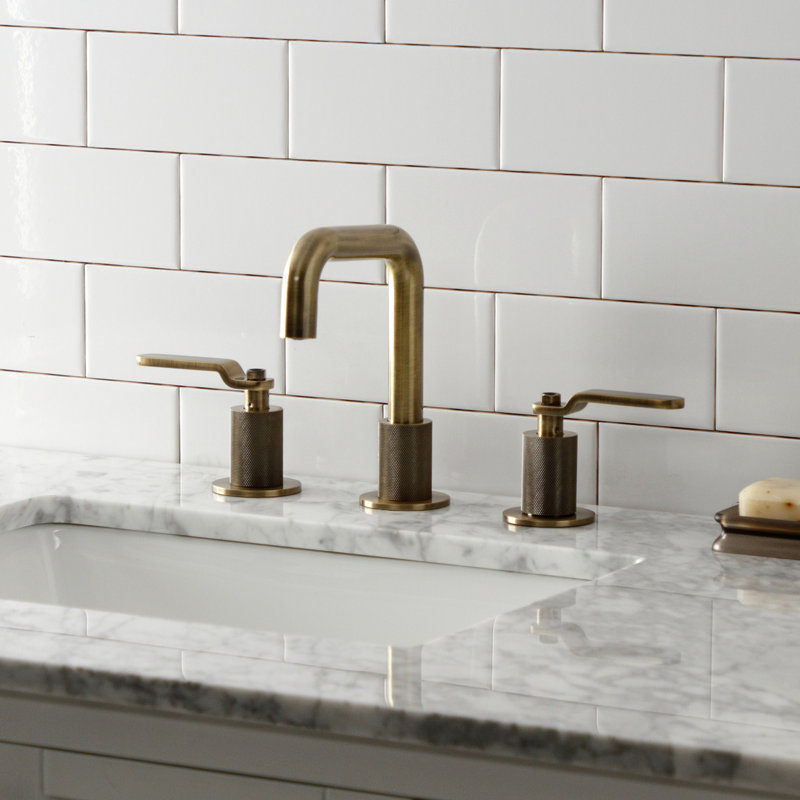Kingston Brass Whitaker Two-Handle 3-Hole Deck Mount Widespread Bathroom Faucet with Push Pop-Up Drain, Antique Brass