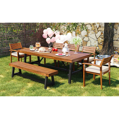 Mobilier de salle à manger d'extérieur en bois 7 pièces pour 8 personnes avec coussins amovibles, banc et adaptabilité intérieur / extérieur