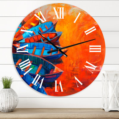 Bateaux se reposant sur l'eau pendant un coucher de soleil chaud - horloge murale nautique et côtière
