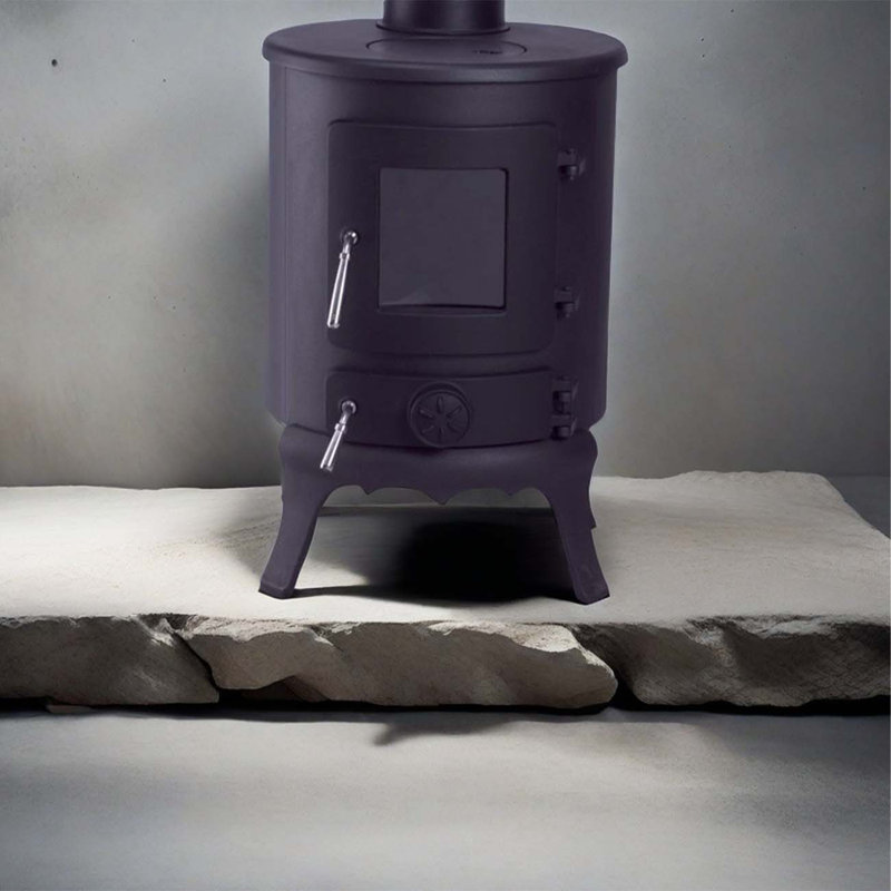 Small cylindrical cast iron wood-burning fireplace