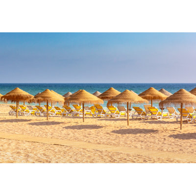 Lounge Chairs And Parasols by MichelGuenette - Wrapped Canvas Print