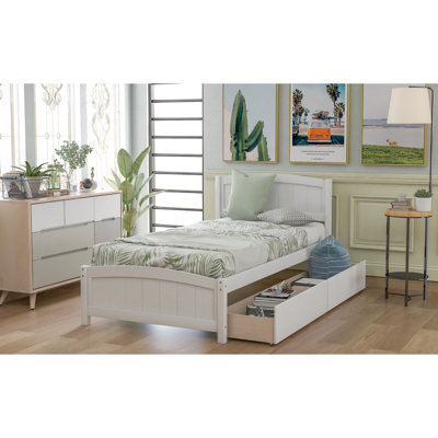 Lit simple blanc avec deux supports de tiroir en bois massif pour une structure de chambre à coucher stable