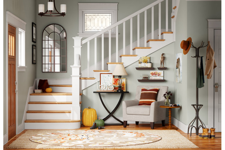 large entryway with a grand white staircase, wood floors, and layered area rugs