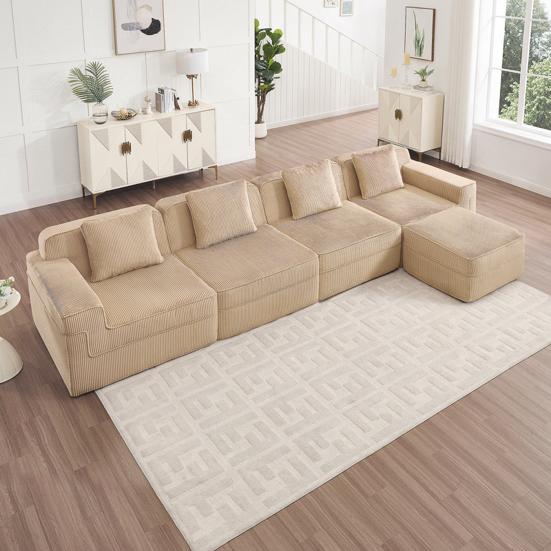 Canapé modulaire moderne en L à 4 places avec sièges profonds, coussins décoratifs et repose-pieds mobile pour un confort et une polyvalence ultimes