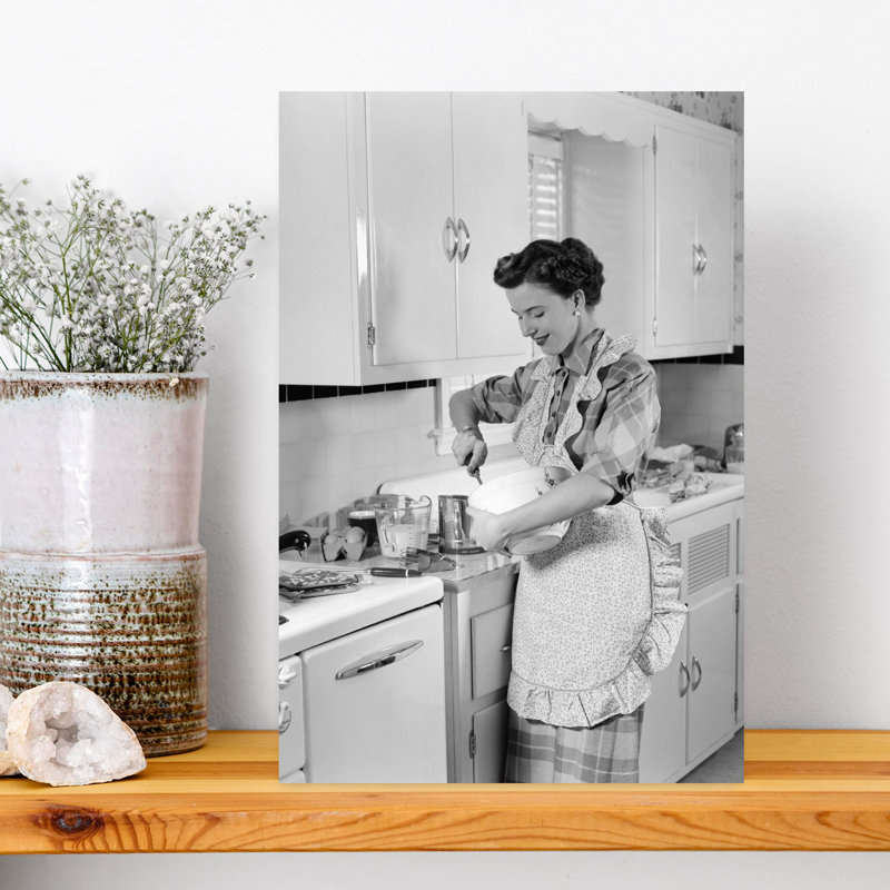 1950s WOMAN HOUSEWIFE IN KITCHEN APRON MIXING BAKING INGREDIENTS IN BOWL by H. Armstrong Roberts - Wrapped Canvas Print