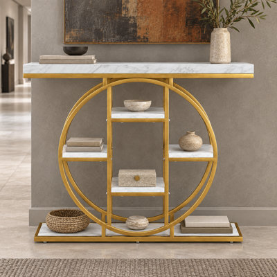 Console moderne et glamour de forme circulaire avec structure en métal et étagère ouverte, idéale pour l'entrée et le salon.
