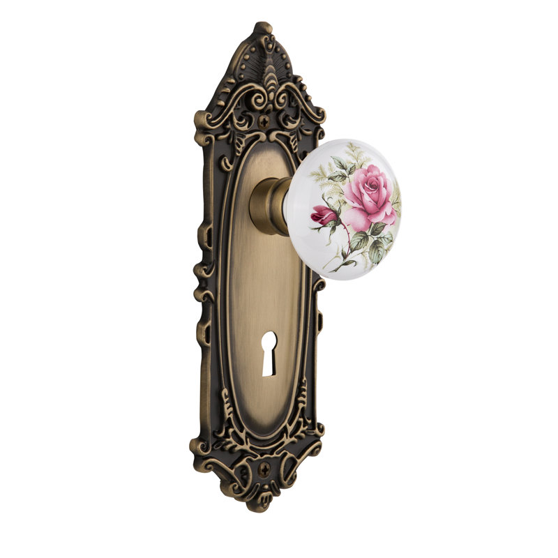 Victorian Plate with Decorative Keyhole and White Rose Porcelain Door Knob, Antique Brass, 2-3/4"