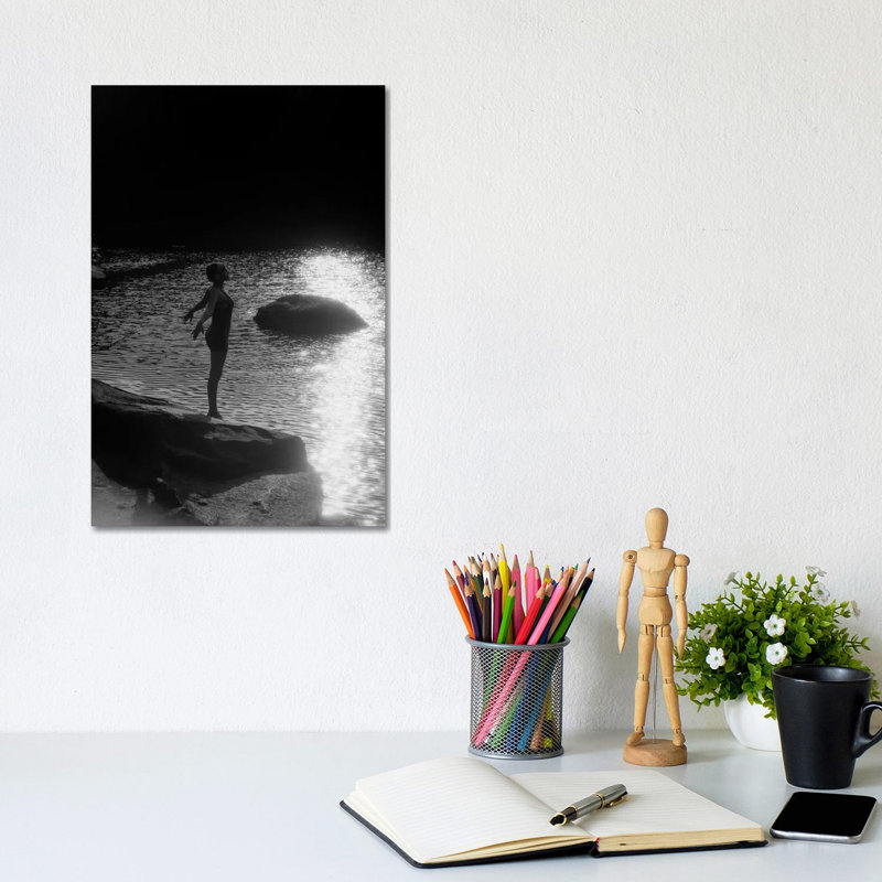 1920s Sunset Silhouette Of Anonymous Woman Standing On A Rock Near Water About To Dive In by Vintage Images - Wrapped Canvas Print