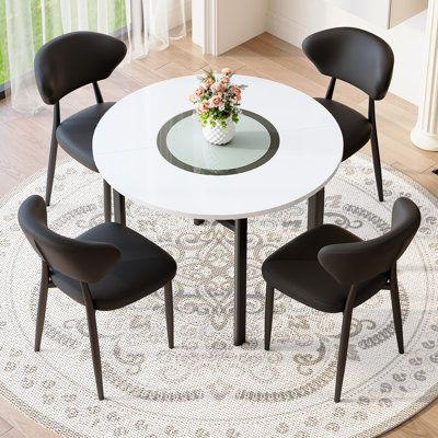 Ensemble de table de salle à manger moderne et minimaliste blanche de 42 pouces. Jumelé avec 4 chaises de salle à manger ergonomiques en polyuréthane noir, avec un dossier incurvé pour une conception confortable.