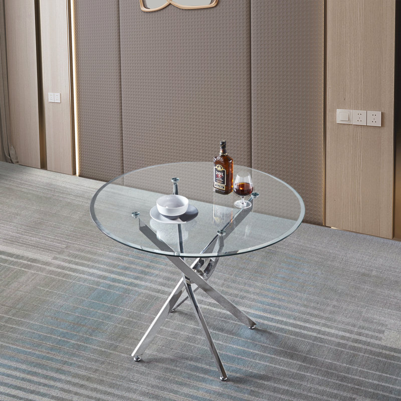 Table de salle à manger ronde contemporaine en verre trempé transparent avec pieds en acier inoxydable à finition argentée