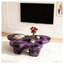 Table basse moderne en faux travertin texturé avec forme de papillon en mauve et noir