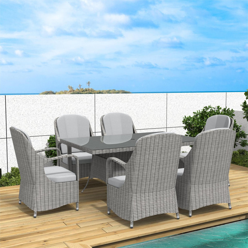 Dustyn 6 - Person Wicker Patio Dining Set with Rectangular Table , Cushions Included