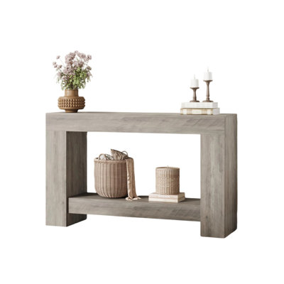 Table d'entrée à deux niveaux avec console de rangement ouverte pour le couloir derrière le canapé et le vestibule