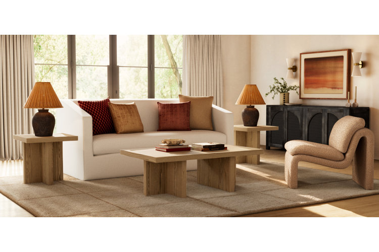 modern living room with two matching table lamps one centered on an end table on either side of a white sofa with red and orange throw pillows