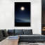 Homme debout regardant une lune brillante dans la nuit - reproduction de photo sur toile tendue-56134051