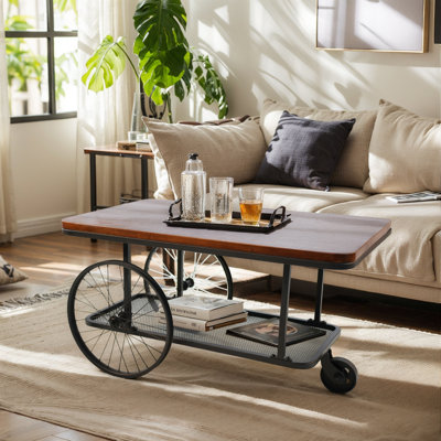 Table basse avec chariot noir, table de centre vintage avec roues pour le salon, structure en métal et plateau en bois, style campagne, 39,37 pouces, noir / brun rustique