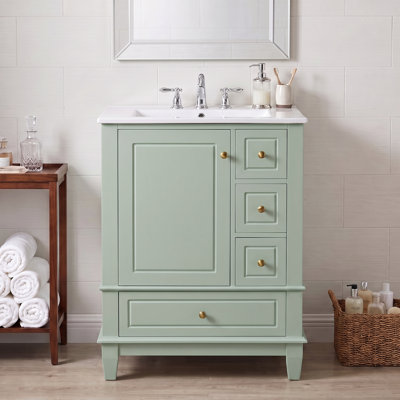 Meuble-lavabo autoportant de 61 cm (24 po) en bois massif et MDF vert, avec lavabo en céramique intégré et rangements.