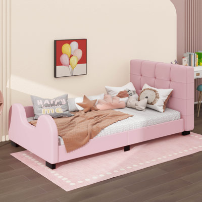 A Twin-Sized Platform Bed Featuring A Padded Frame And A Safety Rail