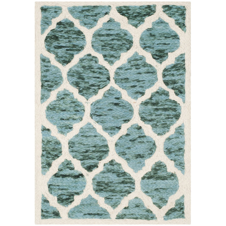 Tapis turquoise / ivoire à motif géométrique en laine Bertok