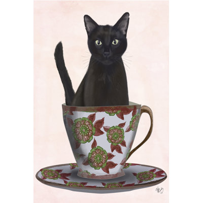 Chat noir dans une tasse de thé