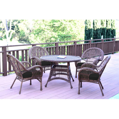 Mangum 4 - Person Wicker Patio Dining Set with Round Table
