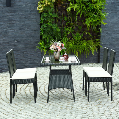 Leotrim 4 - Person Rectangular Patio Dining Set with Cushions included