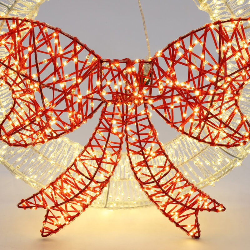 Décoration de Noël avec couronne lumineuse et nœud rouge avec minuterie