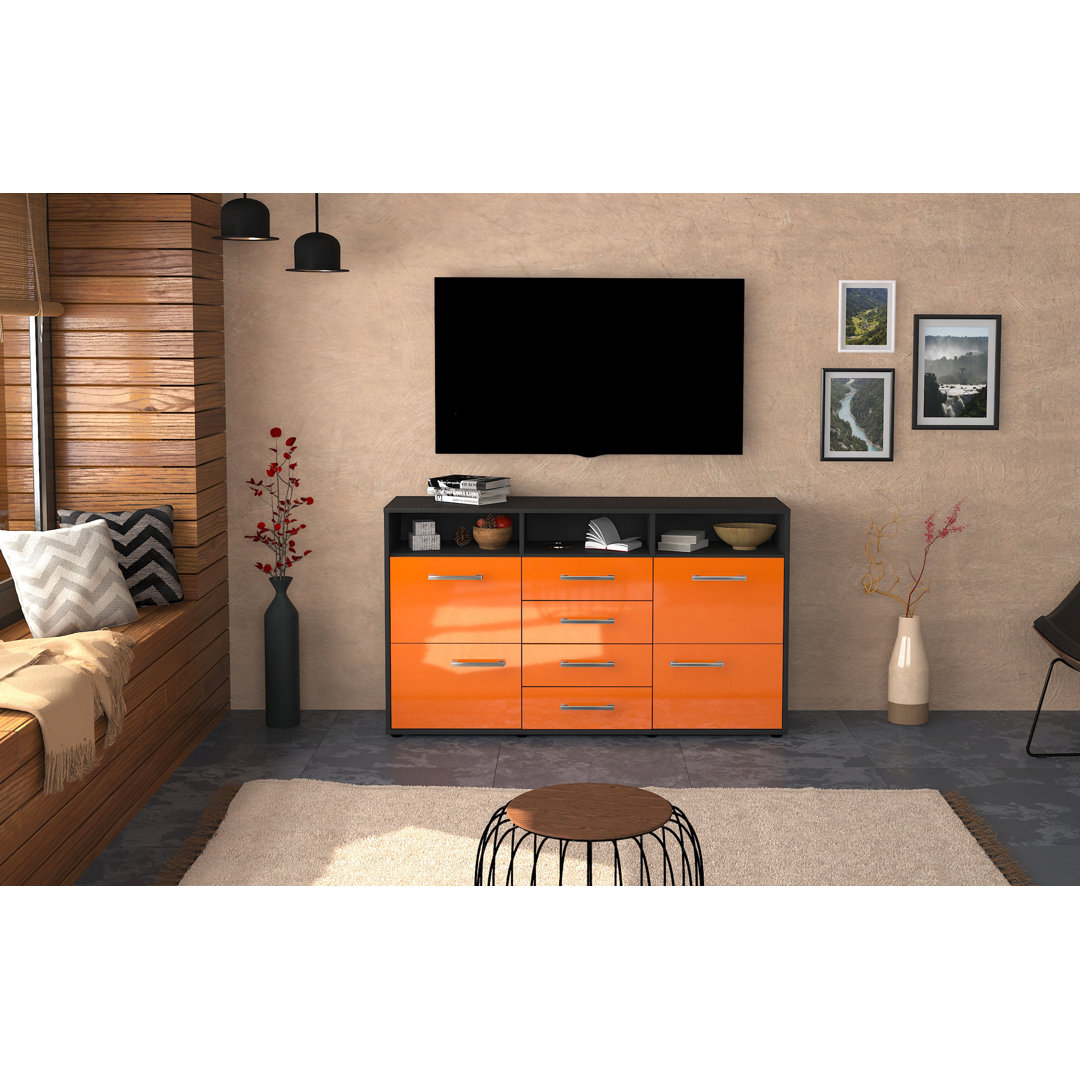 Das Sideboard Donabella hat einen weißen Korpus und eine orange Hochglanzfront. Es misst 136 cm x 79 cm x 35 cm und verf...