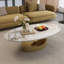 Table basse ovale imitation marbre, 125 x 68 x 39 cm, dessus en pierre frittée, finition blanche et dorée