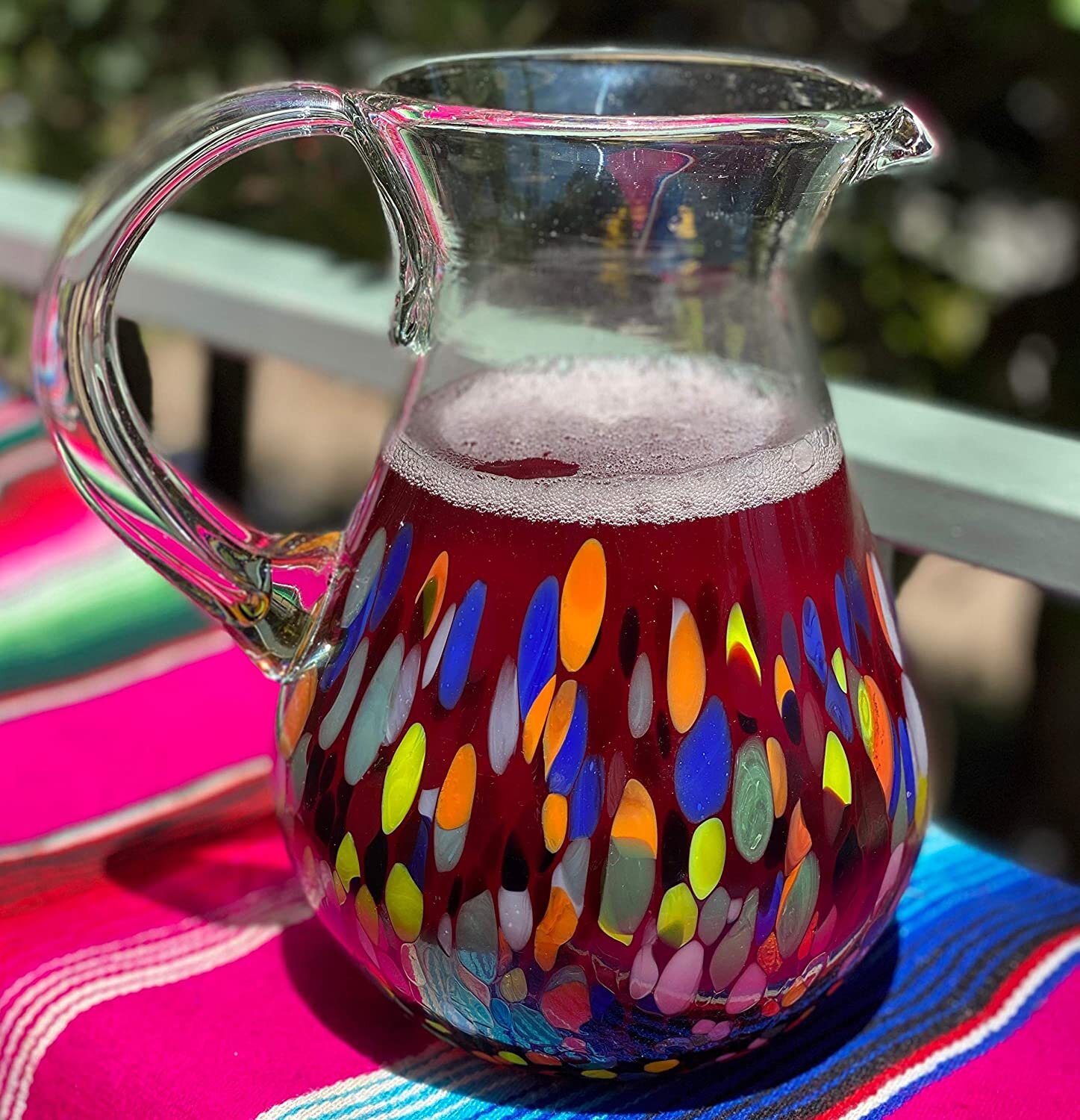 https://assets.wfcdn.com/im/39853735/compr-r85/1227/122747011/glenns-mexican-hand-blown-glass-84-oz-pitcher-confetti-carmen-design.jpg