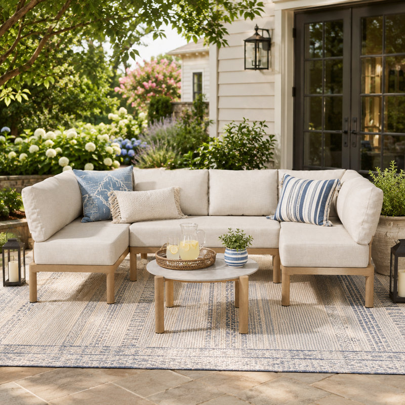 Canapé d'angle modulaire extérieur avec coussins épais et table basse ronde, beige