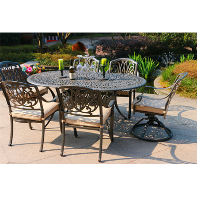 Annecorinne 6 - Person Patio Dining Set Umbrella Hole Included Oval Table with Sunbrella® Cushions Included