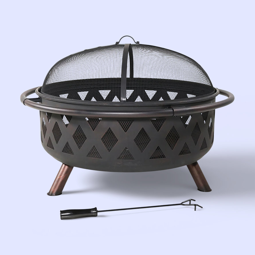 Metal fire pit with spark screen and poker.