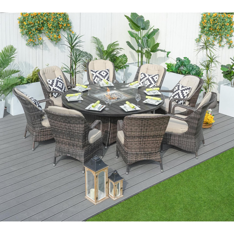 Aquiel 8 - Person Wicker Patio Dining Set with Round Table , Cushions Included