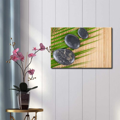 Zen Stones Rocks on a Palm Leaf over a Bamboo Mat - Reproduction de photo sur toile tendue